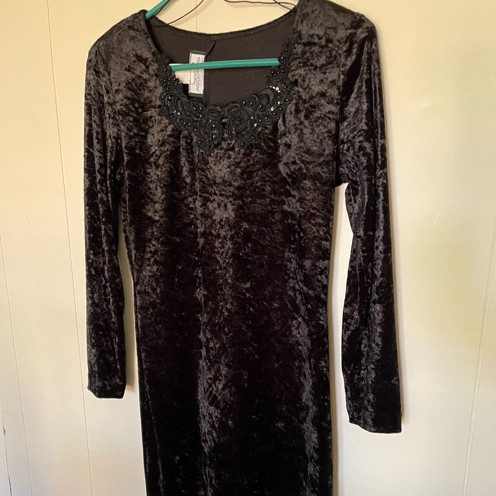 Long sleeve black velvet dress with beaded accents on bodice.